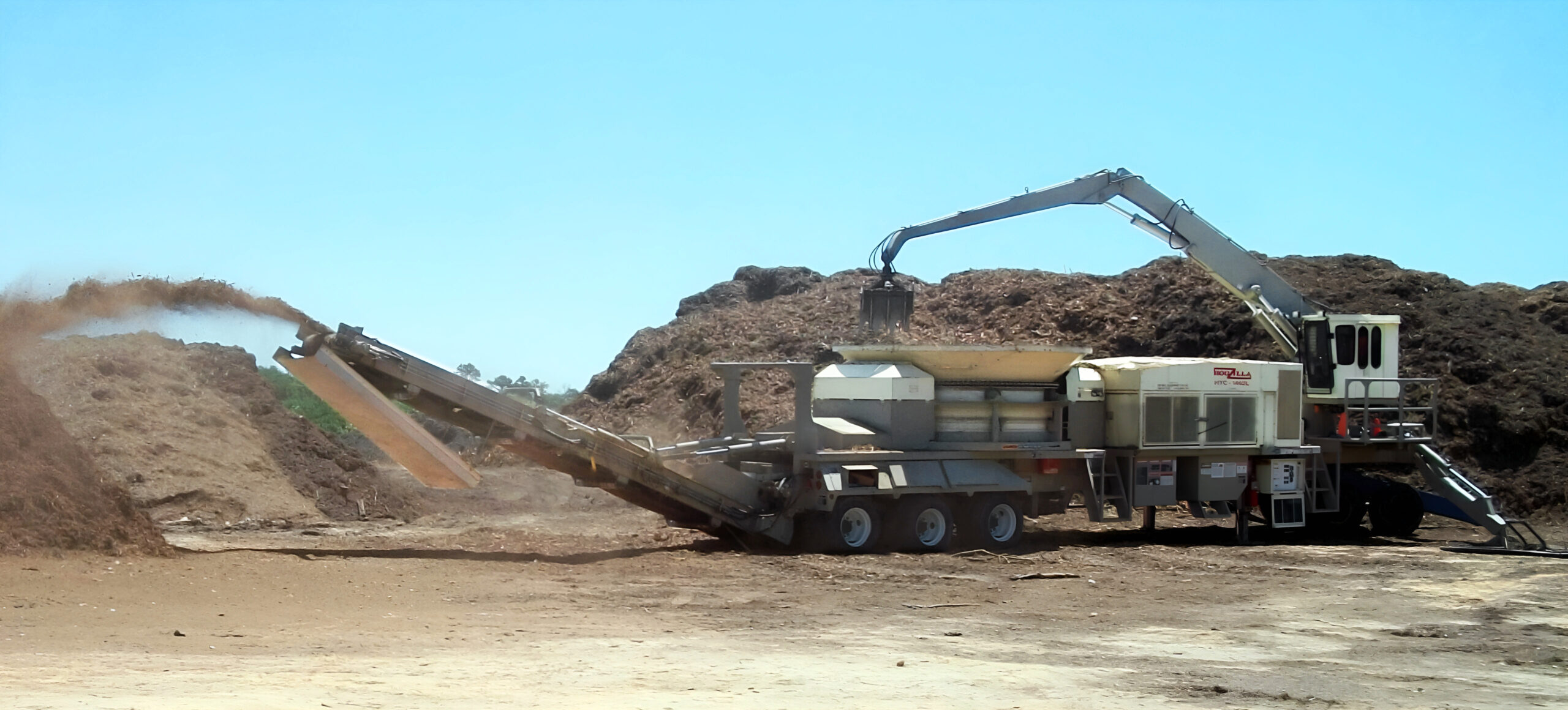 Hogzilla tub grinder with mounted loader
